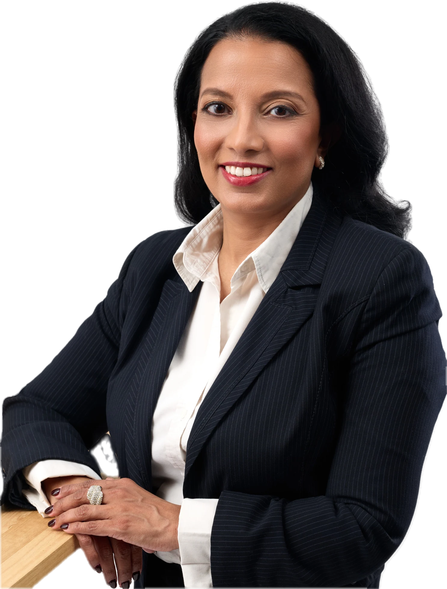 Ishara Saldin in a pinstripe suit, leaning on a table